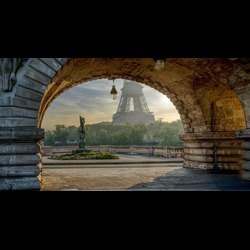 Eiffel Tower view from under a bridge in a park